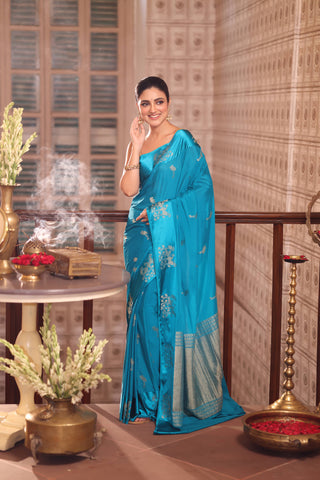 KAVVYA SOFT & LIGHT WEIGHT SKY BLUE CRAPE SAREE WITH SATIN BORDER AND BEAUTIFIL SILK ZARI WEAVING BORDER AND SMALL FLAMINGO MOTIFS ALL OVER THE SAREE COMES WITH SAME COLOUR WEAVED BLOUSE