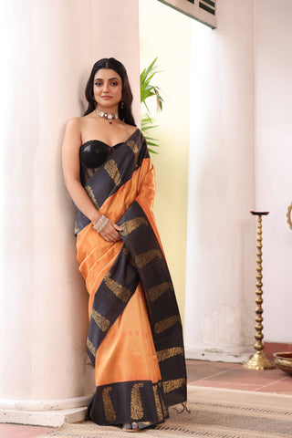 KAVVYA SOFT & LIGHT WEIGHT ORANGE SILK SAREE FITH FINE GOLDEN ZARI WEAVING ALLOVER WITH CONTRAST BLACK BORDER AND PALLU HIGHLIGHTED WITH BEAUTIFUL MOTIFS.