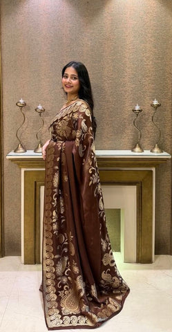 Premium brown saree adorned with intricate gold floral patterns.