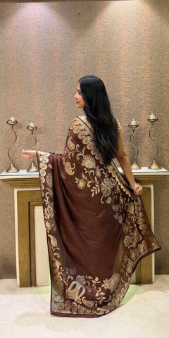 Premium brown saree adorned with intricate gold floral patterns.