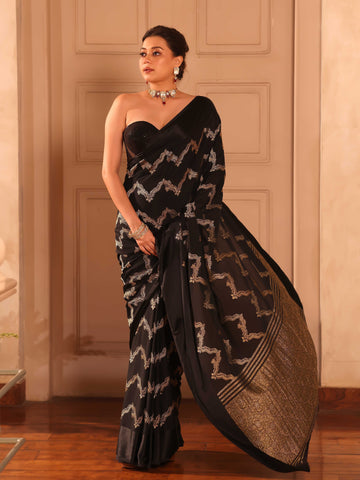 KAVVYA  BLACK CRAPE SAREE WITH ALL OVER GOLDEN ZARI